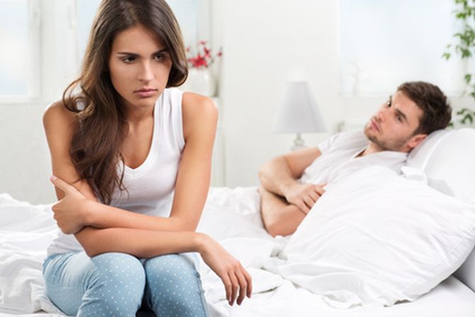 unhappy young couple in bedroom