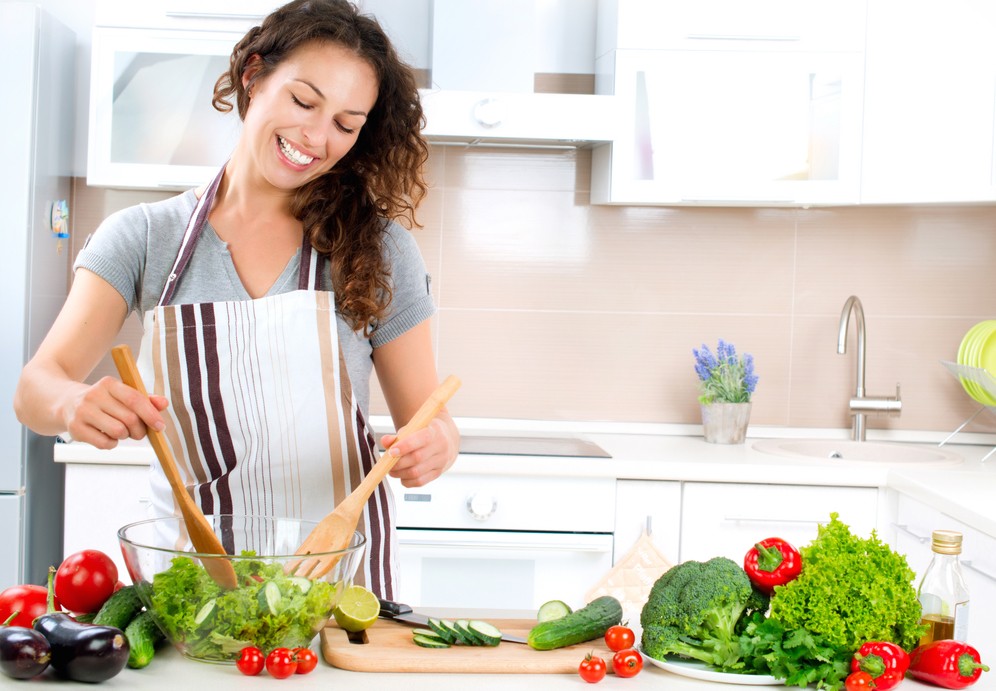 Young Woman Cooking. Healthy Food - Vegetable Salad